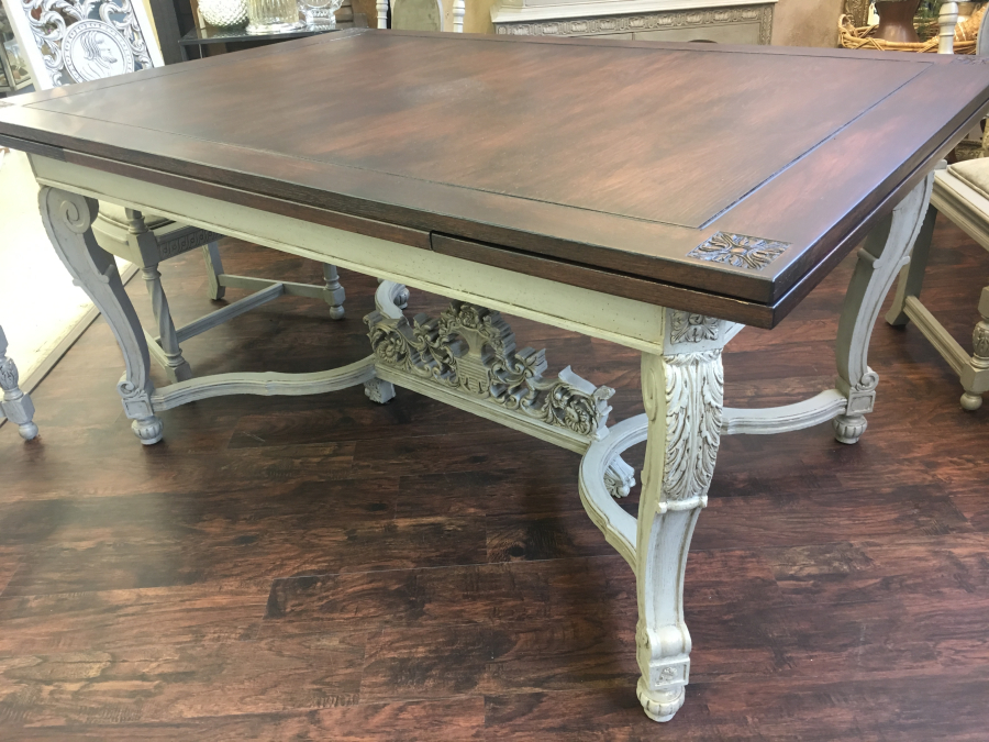 Table with walnut stained top on ornate painted base.