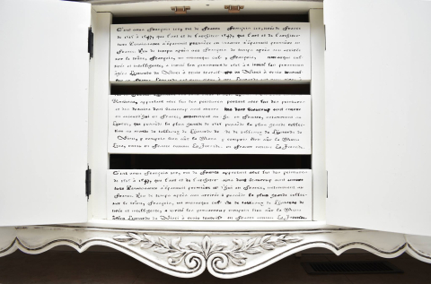 French Script stenciled on the front of the middle drawers