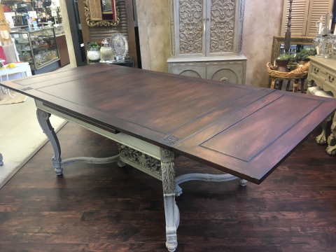 Table fully extended with two self-storing leaves.